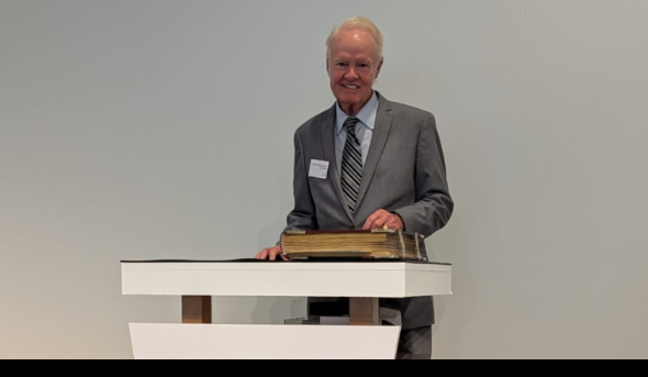 A man stands behind a podium.